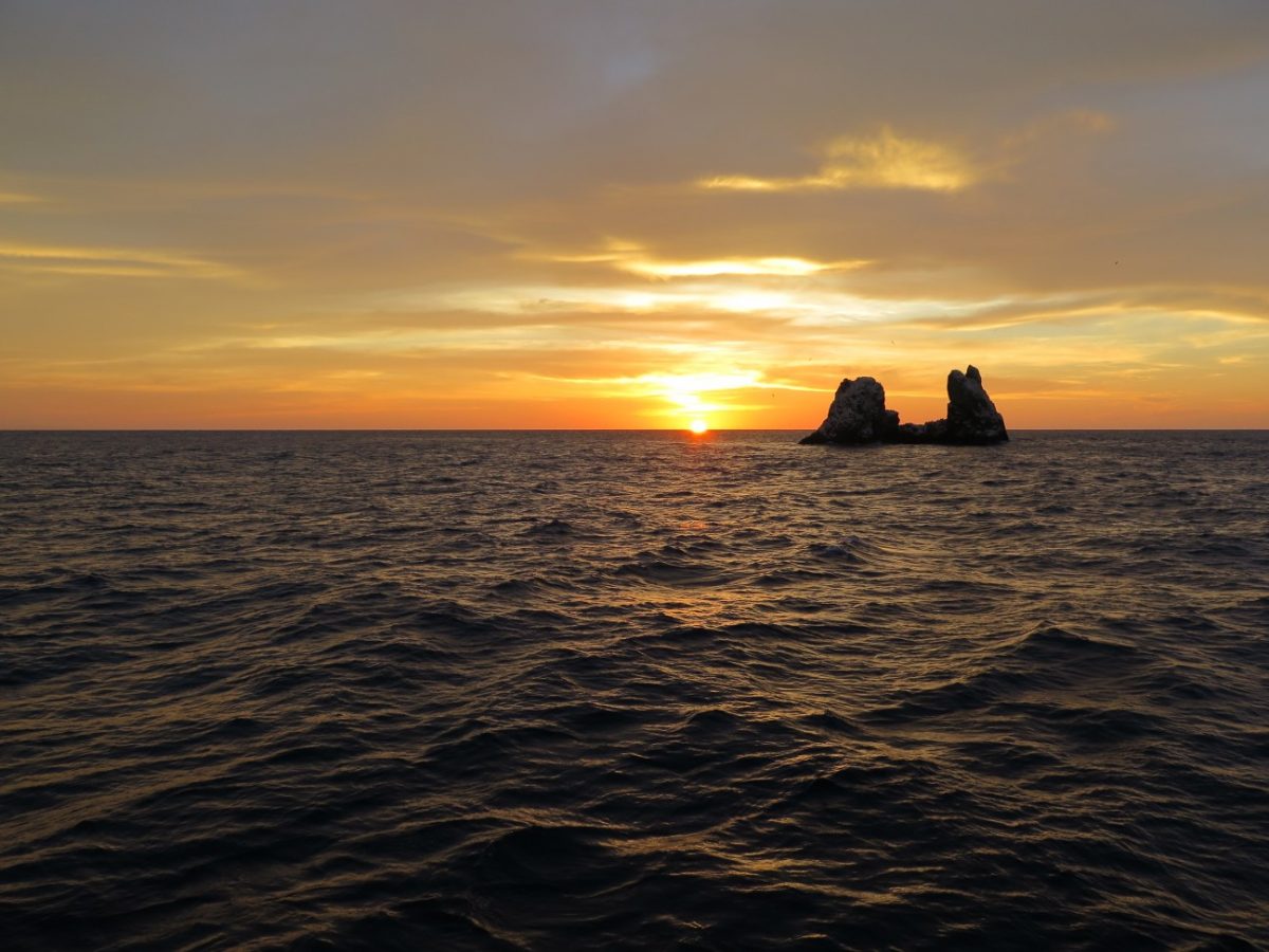 roca partida silhouetted against the glowing sunset