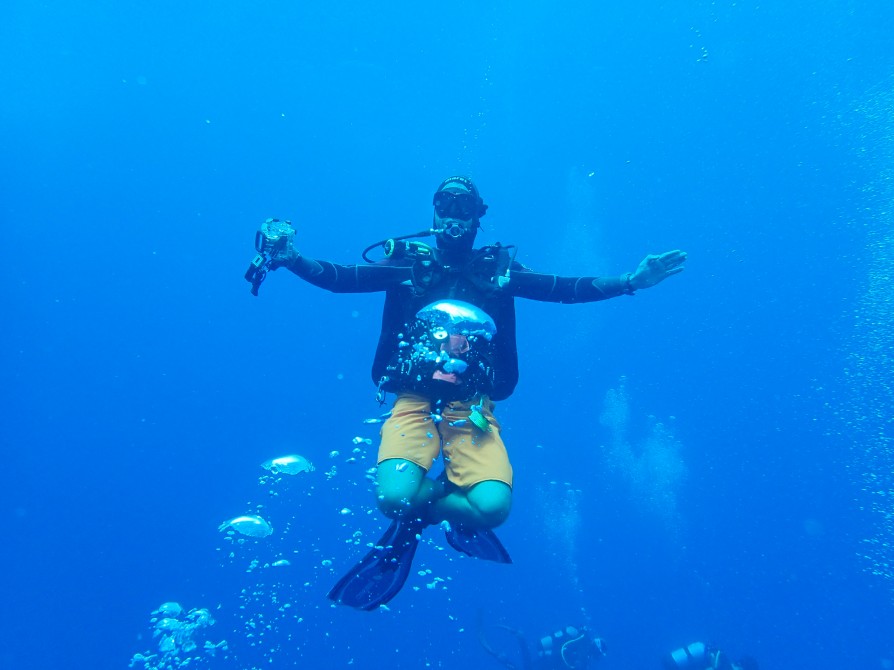 diver poses cross legged for the camera